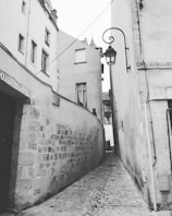 Historic city alleyway lined with charming old buildings and cobblestone paths.