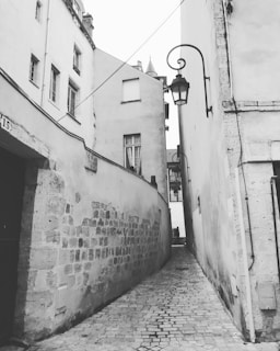 Historic cobblestone alleyway lined with charming old buildings in an Italian town