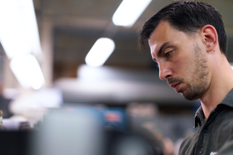 Close-up of Alejandro Cuadra focused at work in a dark-themed creative studio.