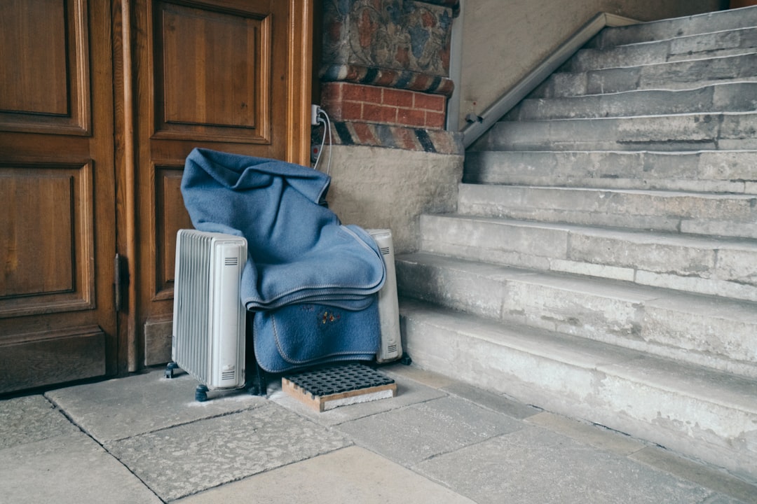 blue and black backpack on gray concrete stairs