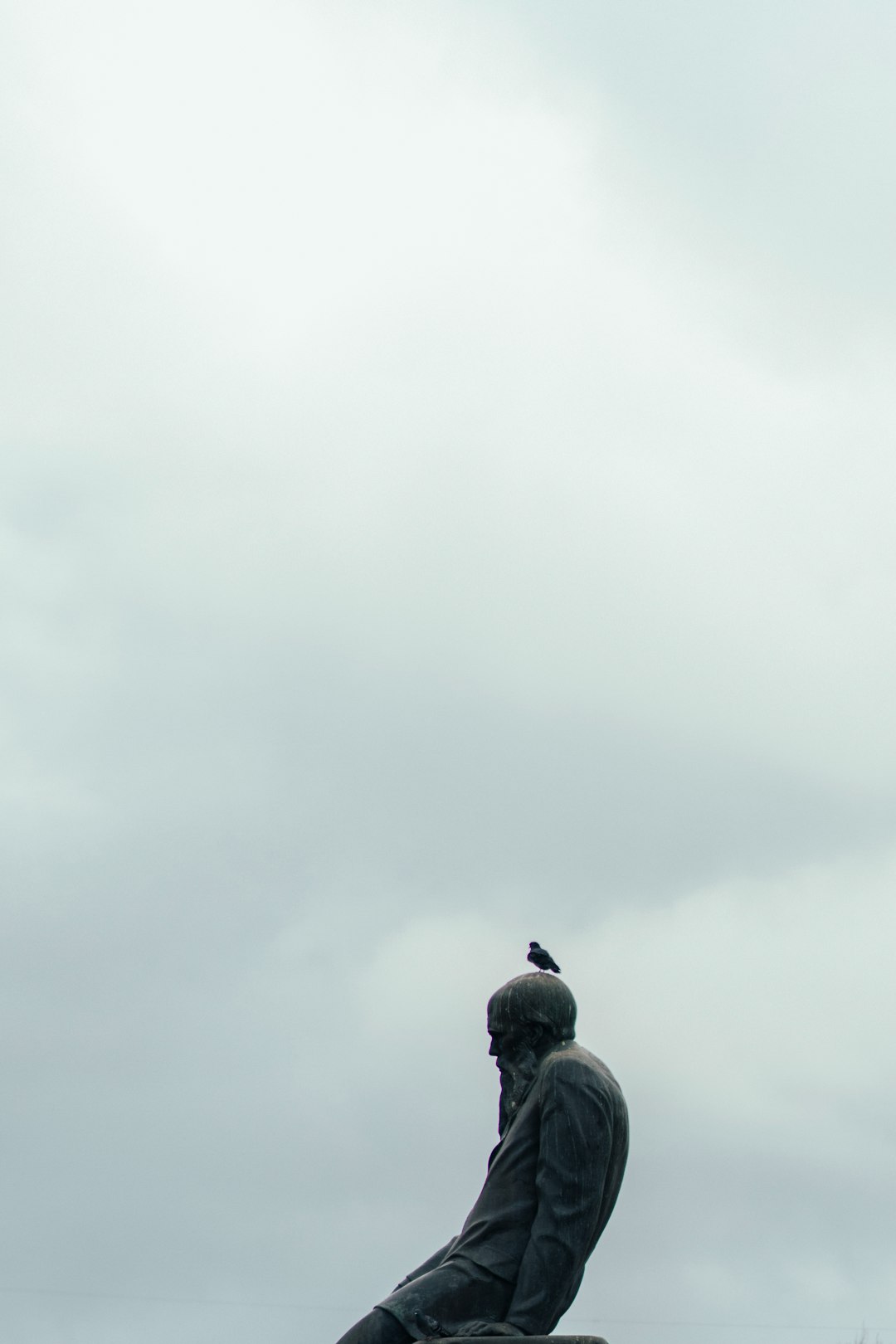 man in black jacket standing under white cloudy sky during daytime