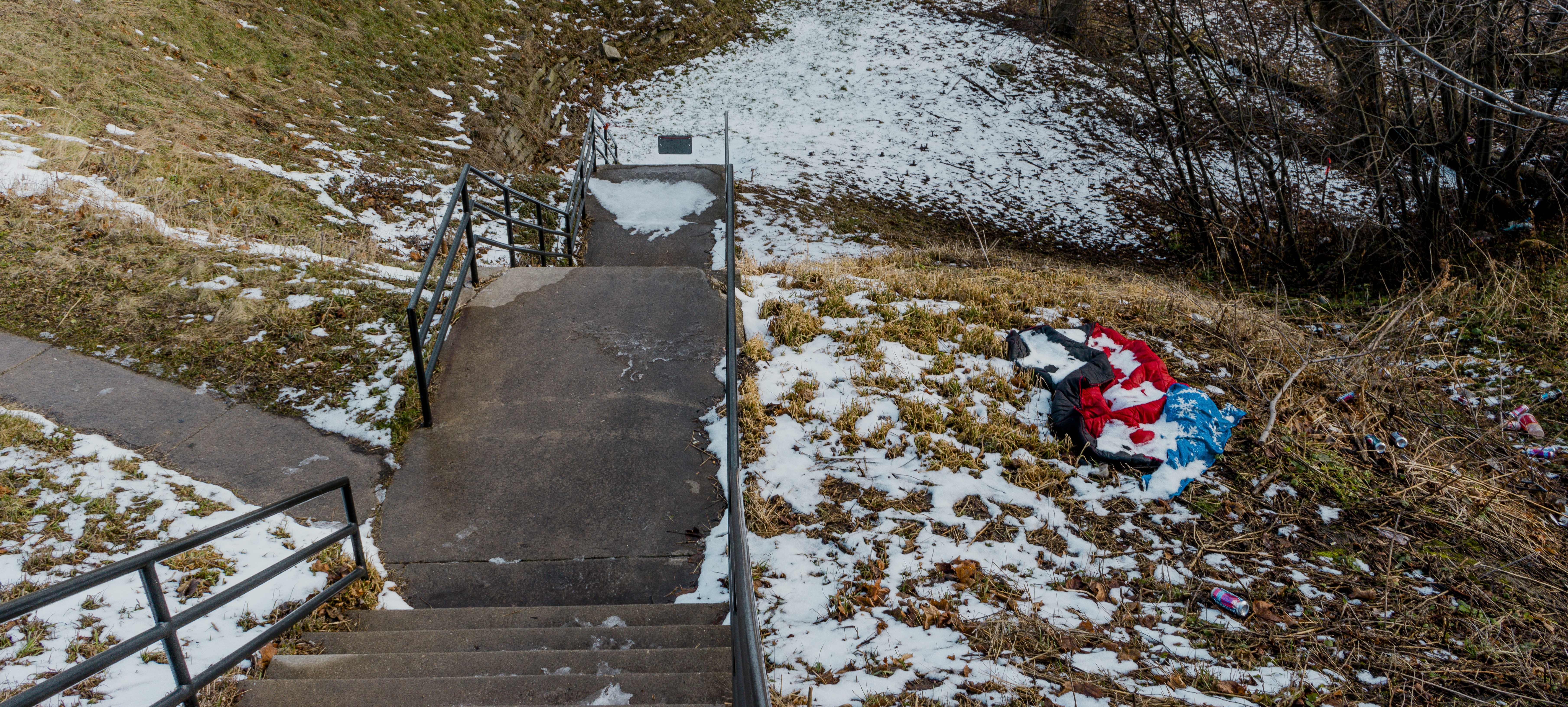 brown wooden staircase covered with snow