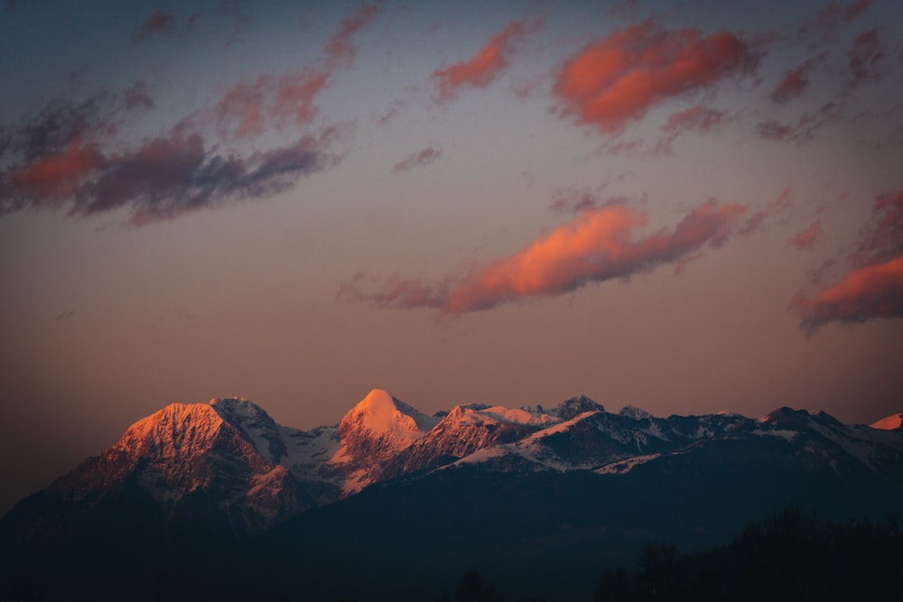 brown and white mountains under cloudy sky during daytime