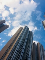 low angle photography of high rise buildings under blue sky during daytime