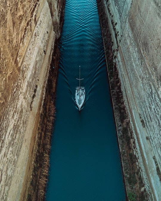 white boat on water during daytime in Isthmos Korinthou Greece