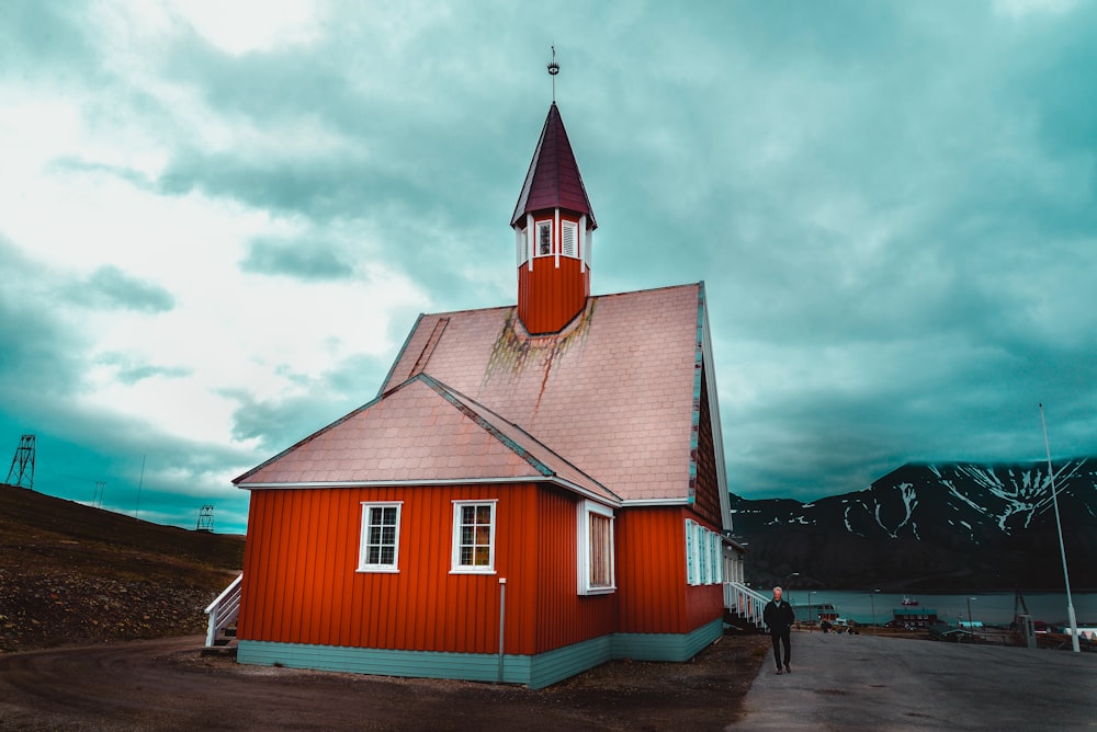 red and brown wooden house under cloudy sky during daytime