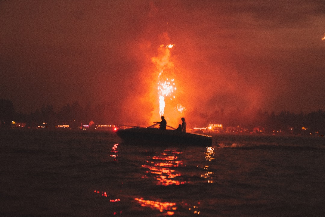 silhouette of 2 people on boat during sunset