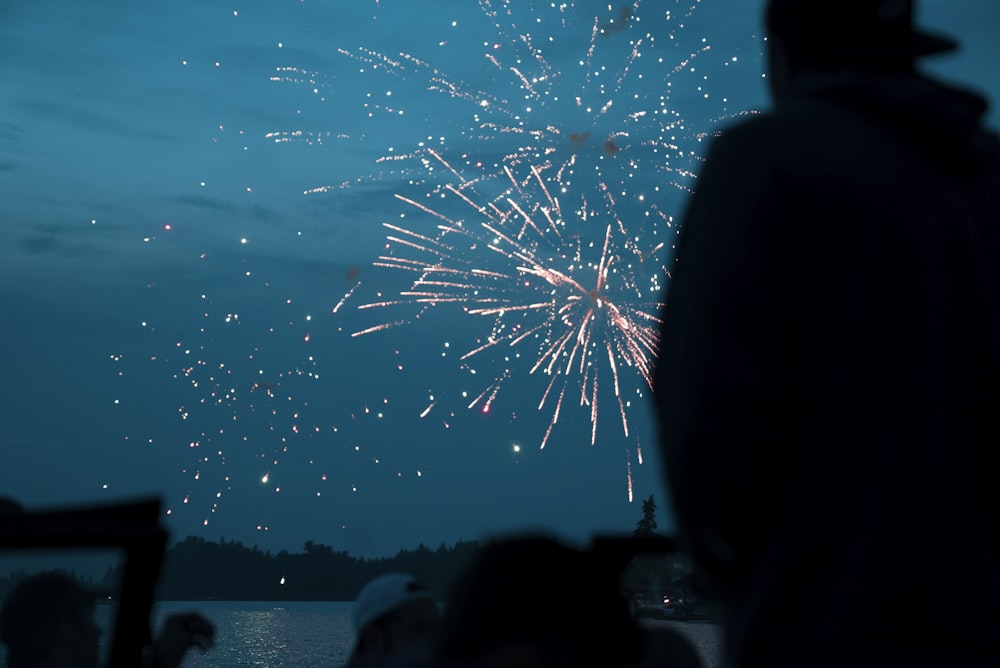 a crowd of people watching a fireworks display