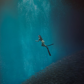 man in black shorts swimming in water