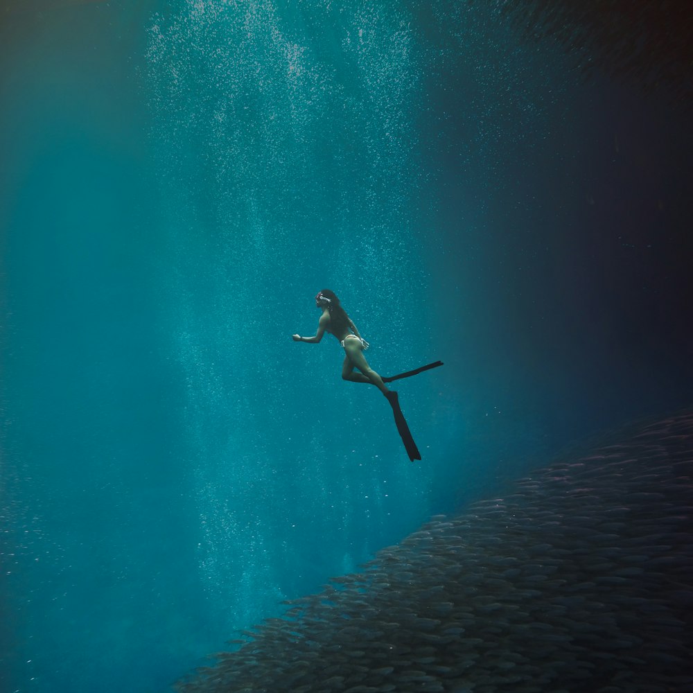 man in black shorts swimming in water