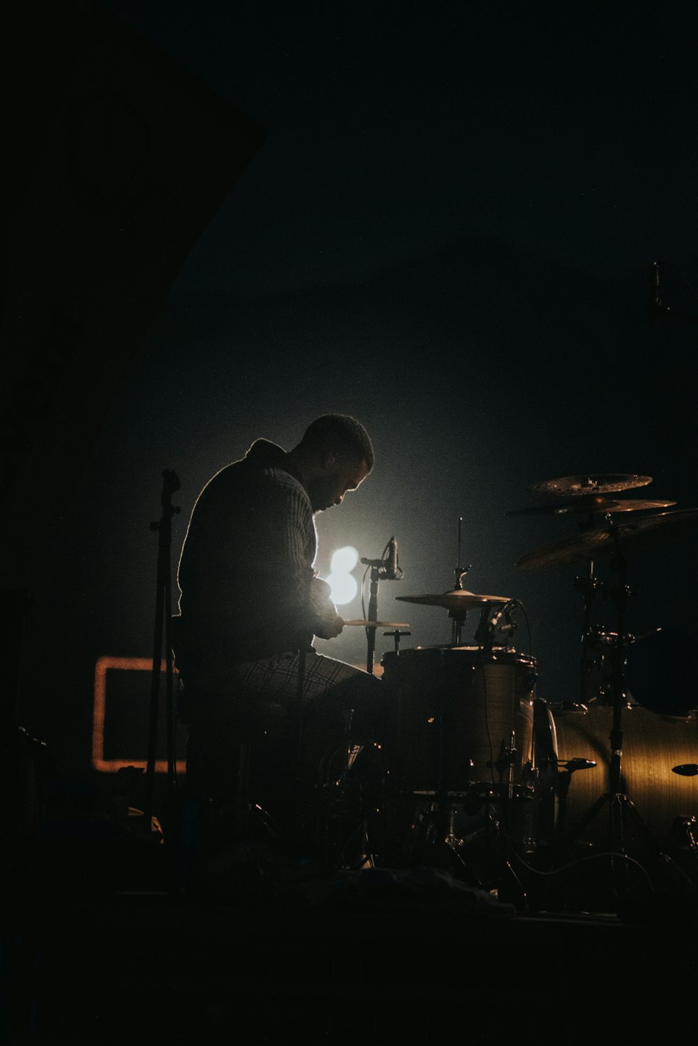 man in black jacket standing on stage