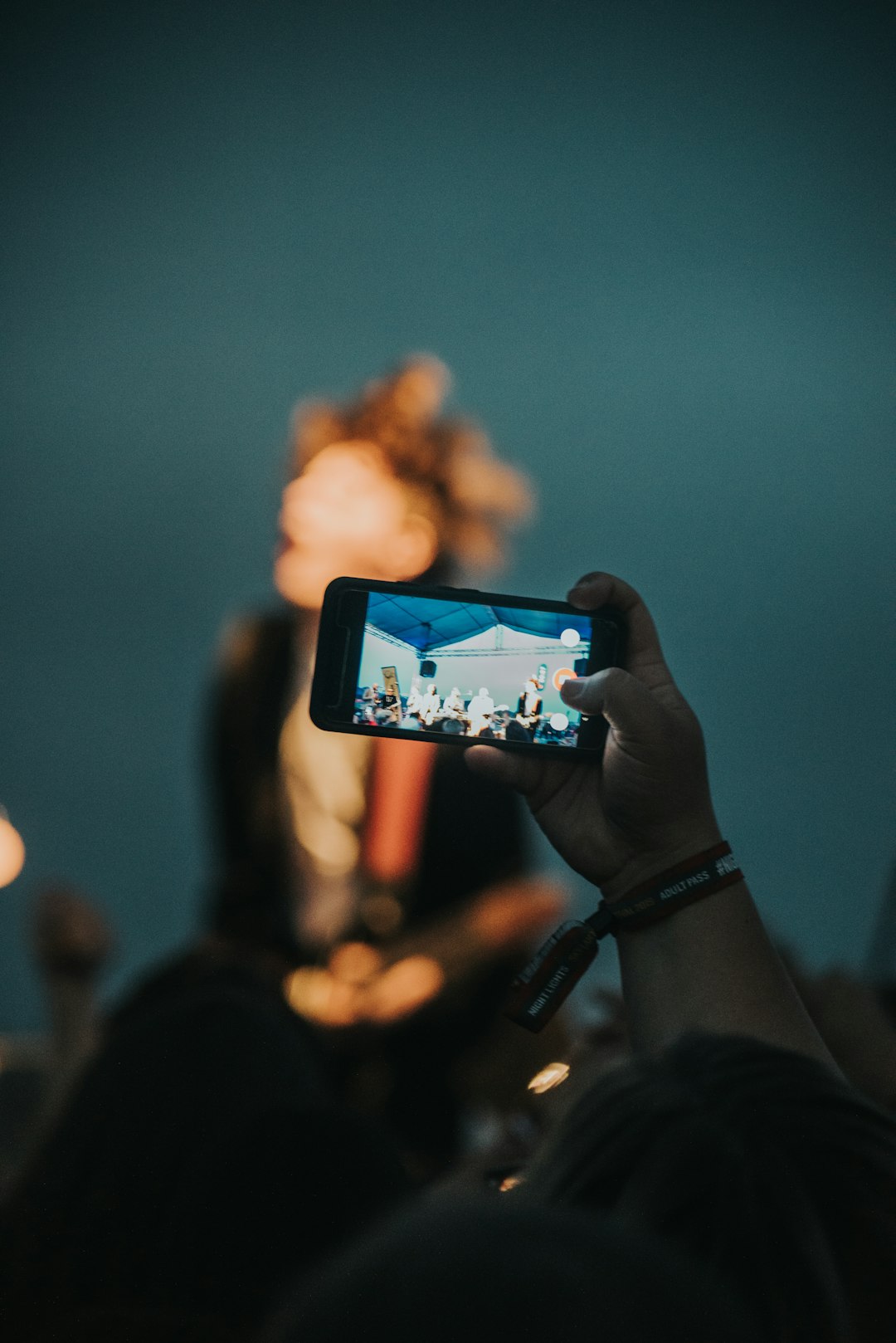 person holding black smartphone taking photo of brown mountain during daytime