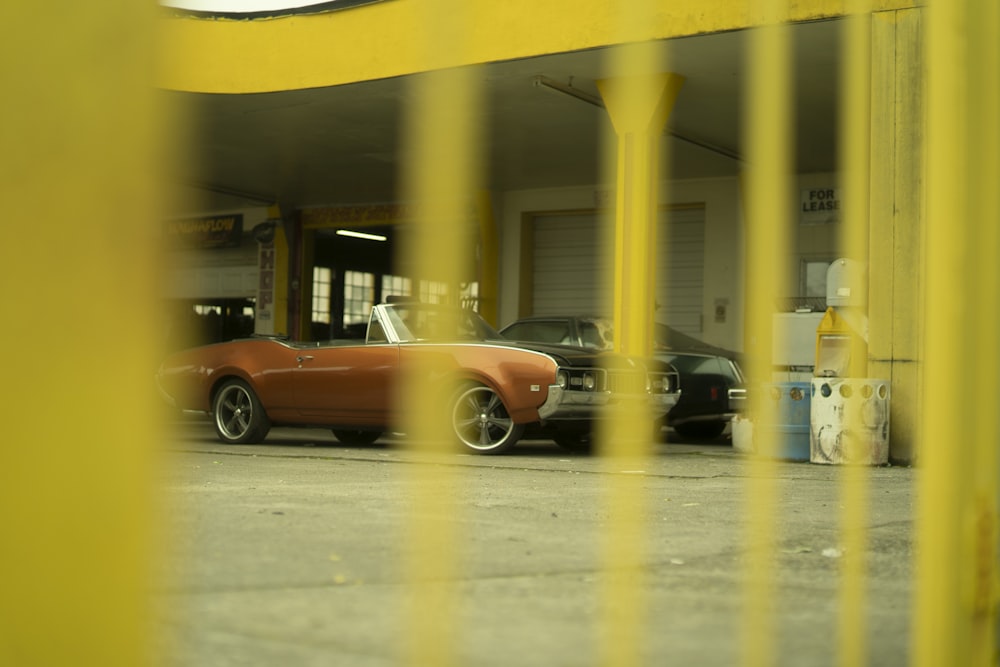 red coupe parked in front of building