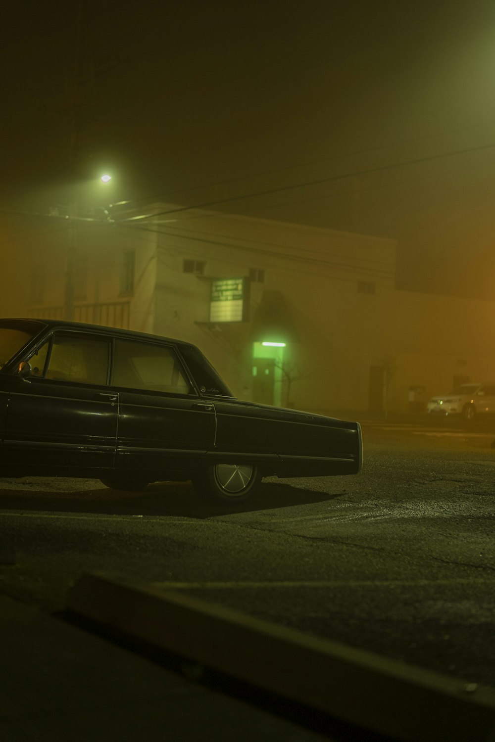 black sedan on road during night time