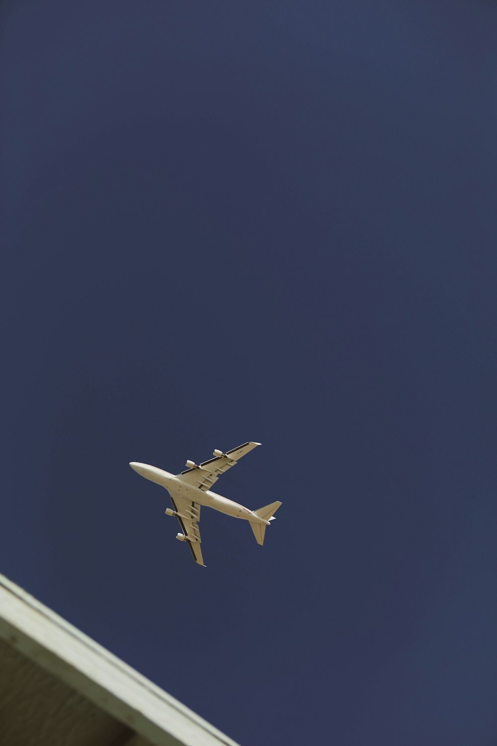 white airplane in mid air during daytime
