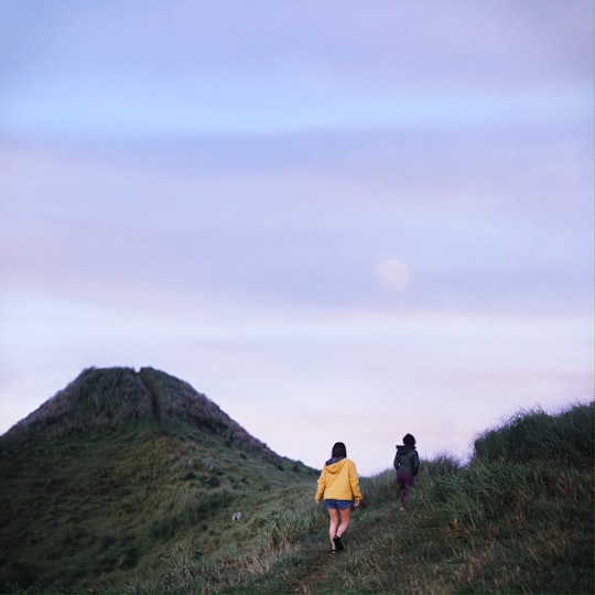 2 women walking on green grass field during daytime in Batangas Philippines