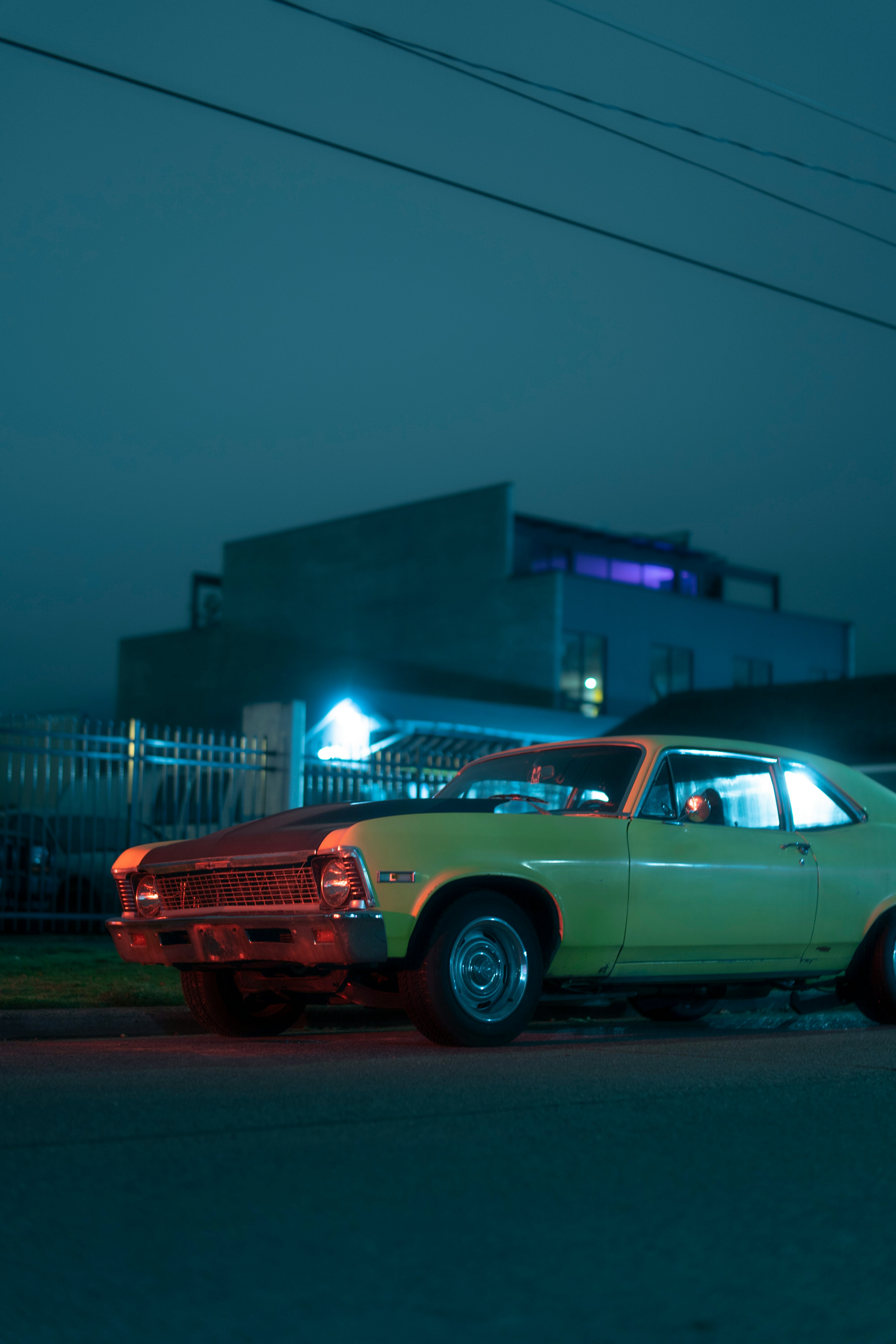 white and red vintage car on road during night time