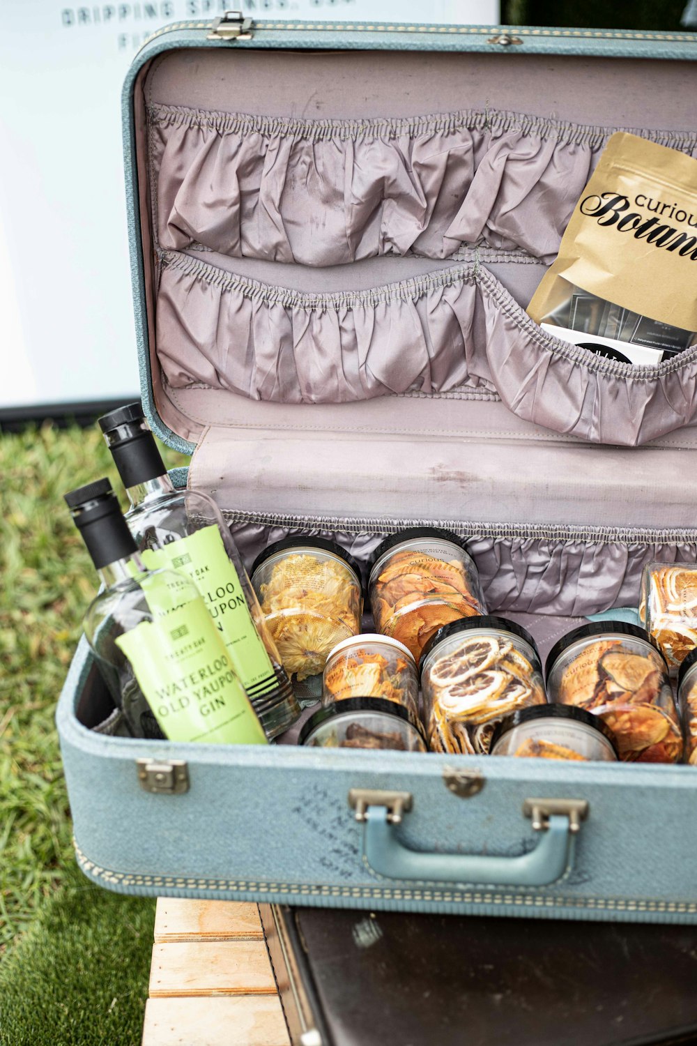 assorted bottles in gray suitcase