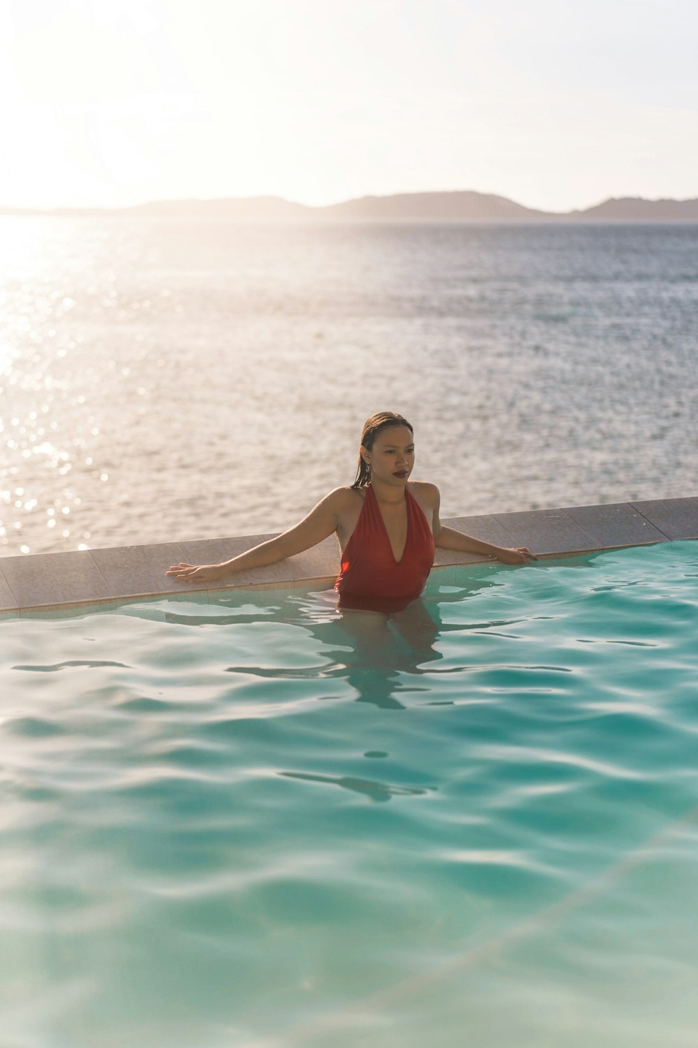 woman in red swimsuit in swimming pool during daytime