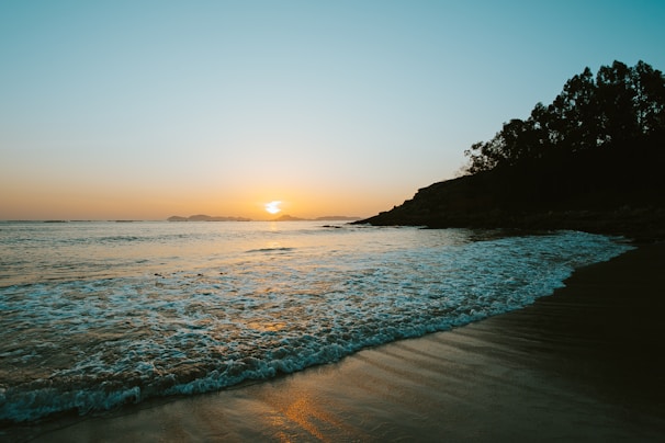 A peaceful beach scene at sunset, symbolizing tranquility.