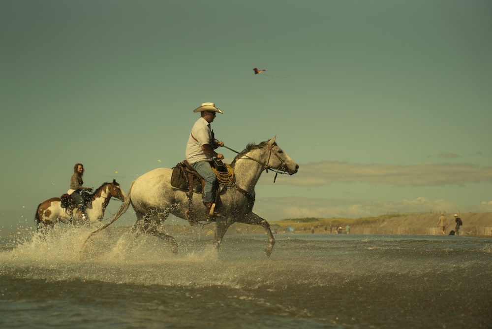 a man riding on the back of a white horse