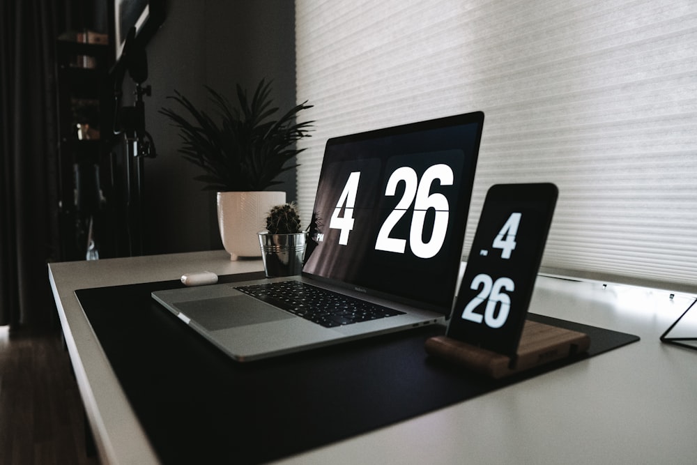 black laptop computer on white table