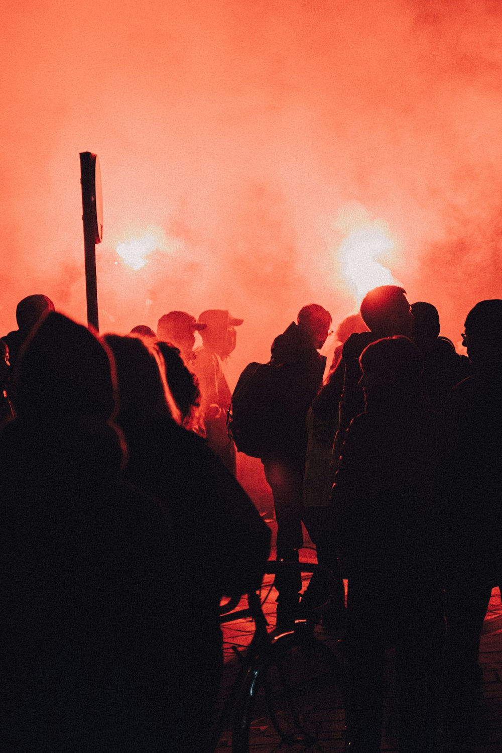 people standing and standing on the field during night time