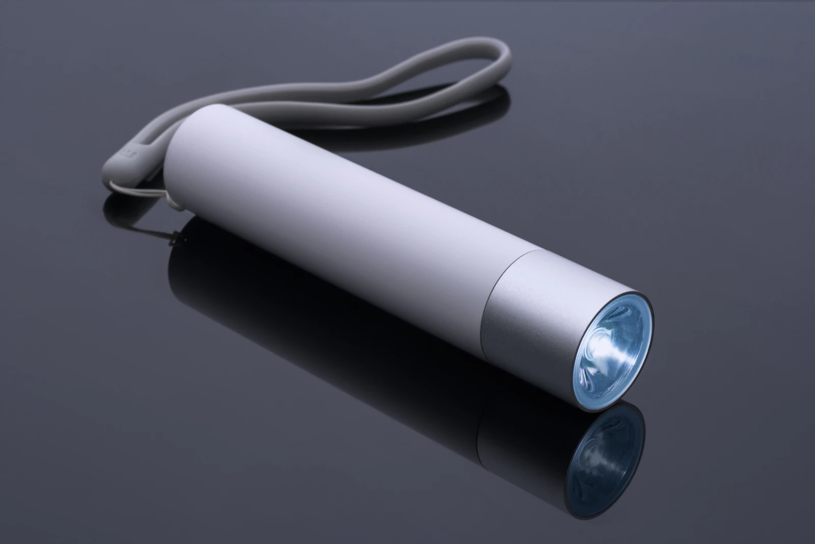 A battery torch and light bulb laid out on a table