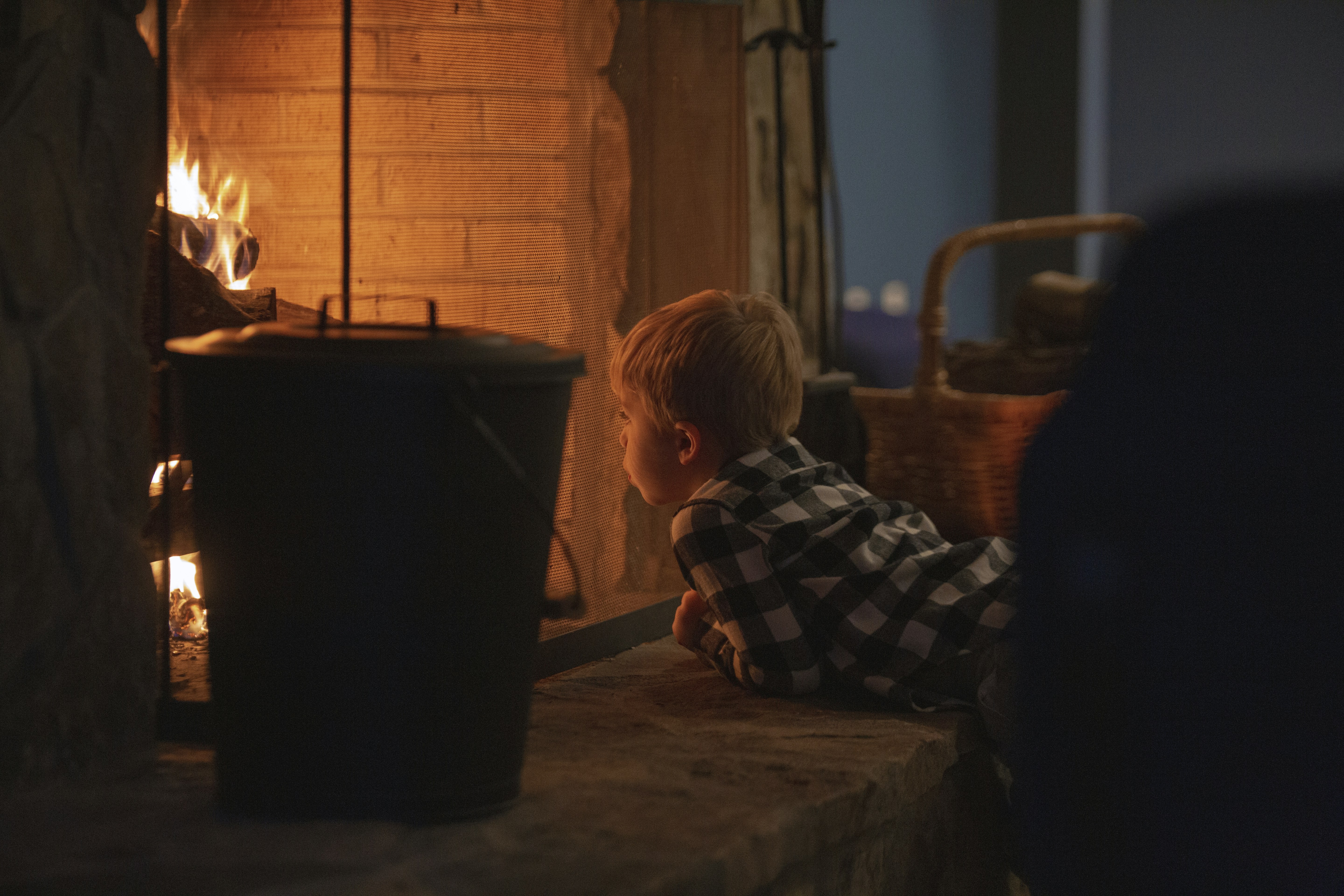 child in black and white striped long sleeve shirt sitting on floor