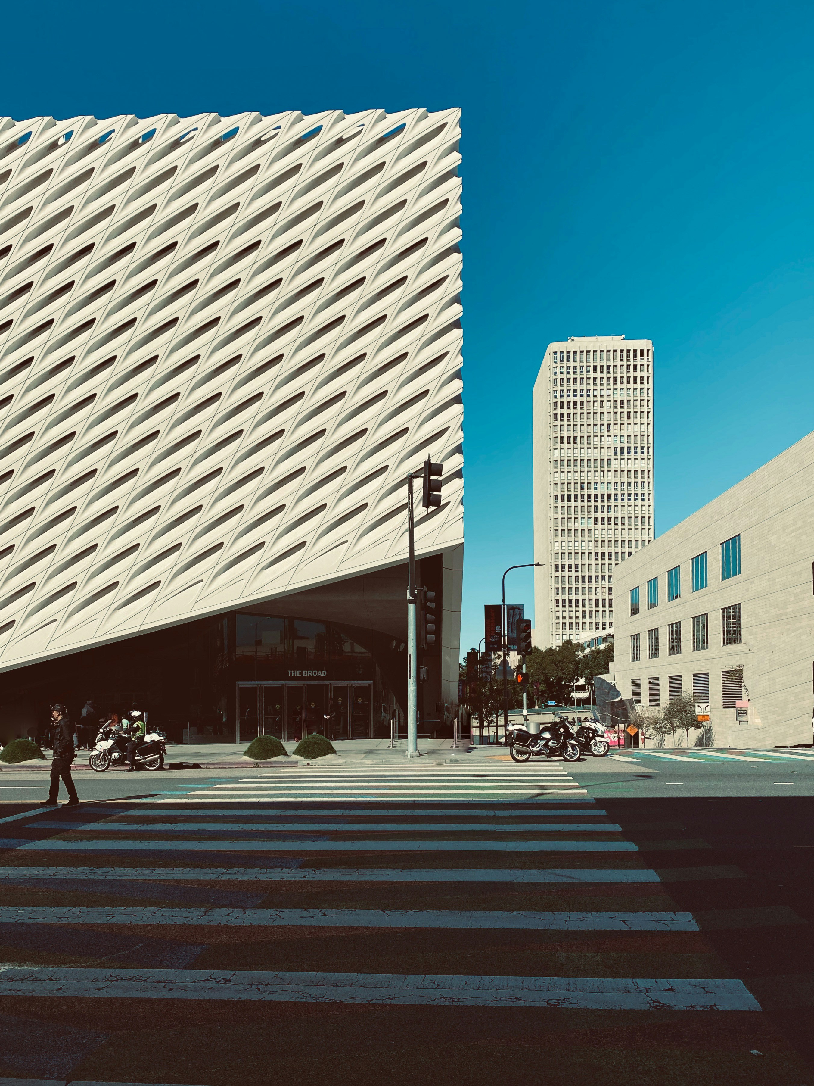 people walking on pedestrian lane near white concrete building during daytime