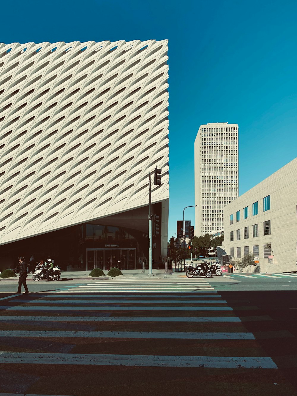 people walking on pedestrian lane near white concrete building during daytime