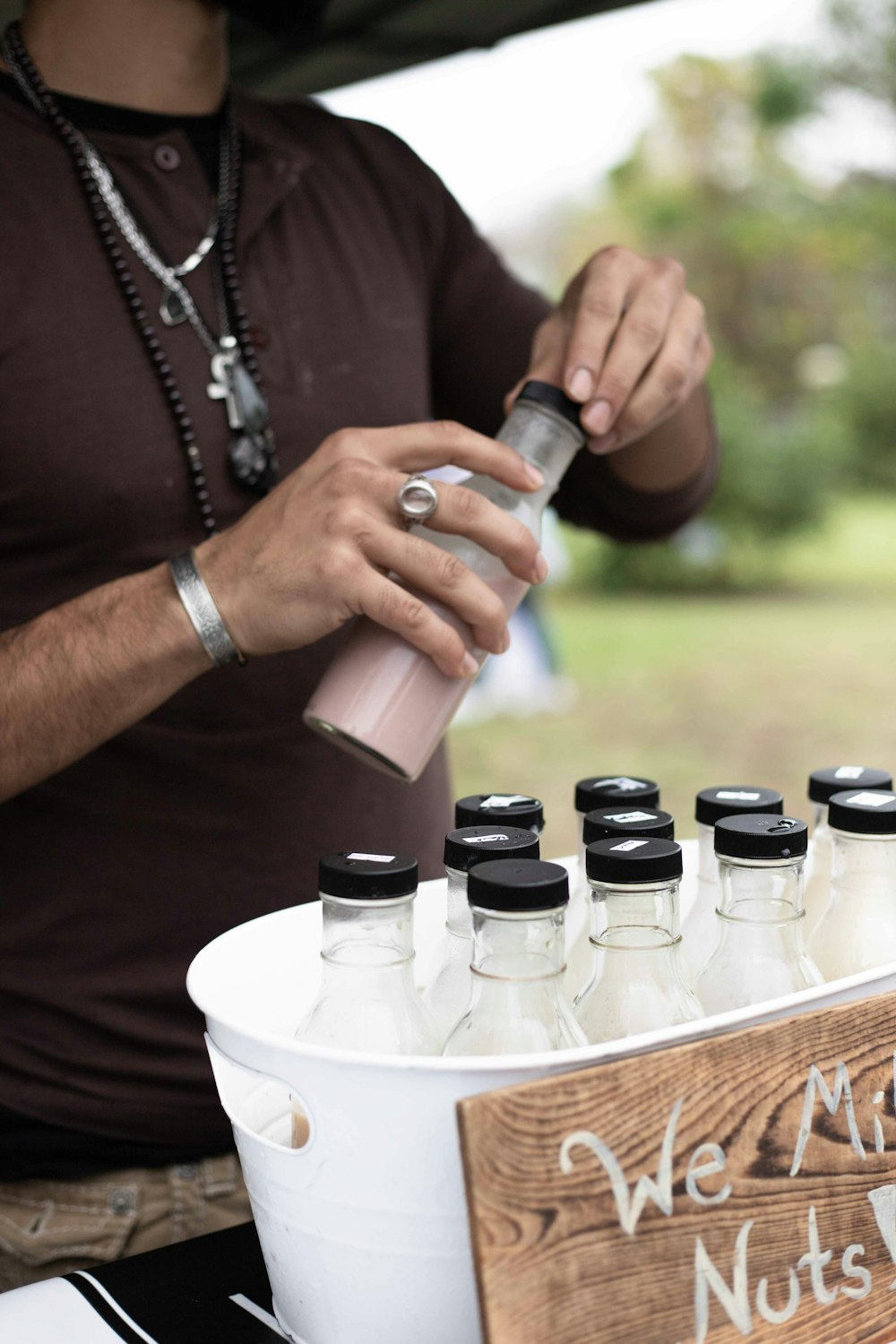 person holding black and white plastic bottles