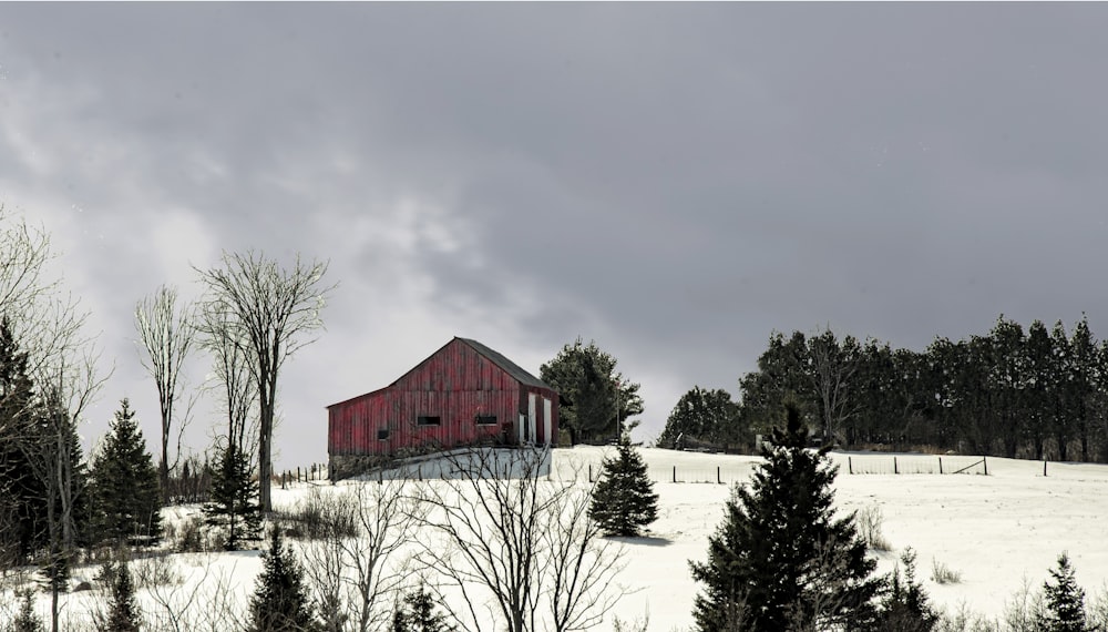 red barn house on snow covered ground