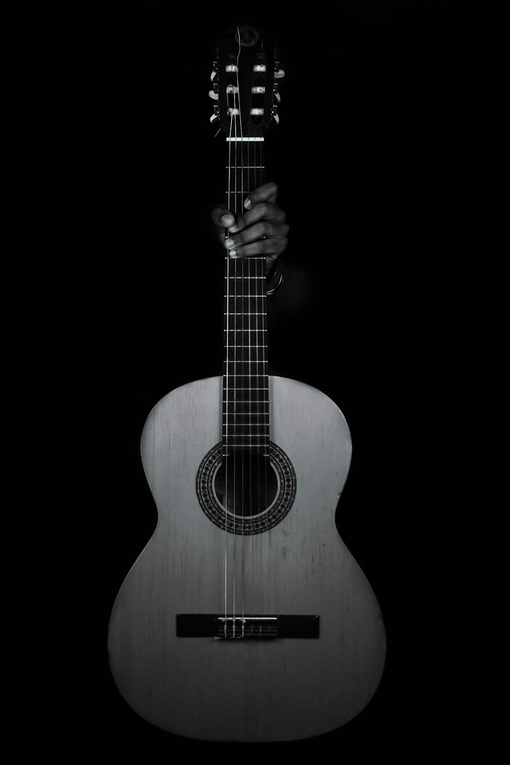 brown acoustic guitar on black background