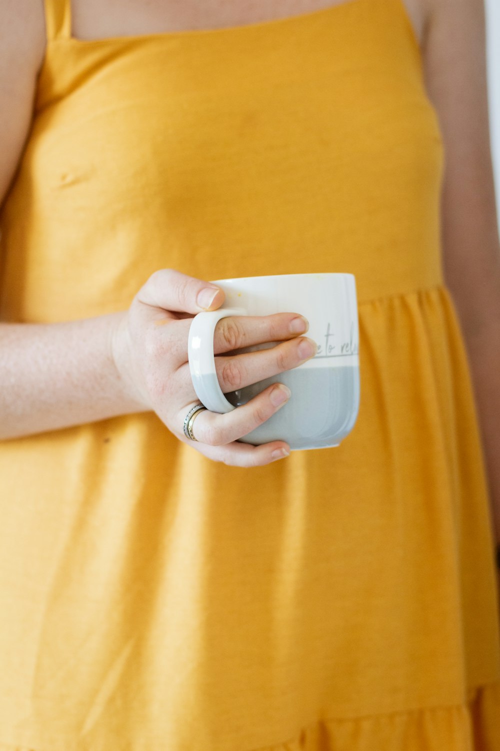 person holding white plastic cup