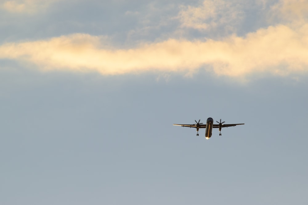 black plane in mid air during daytime