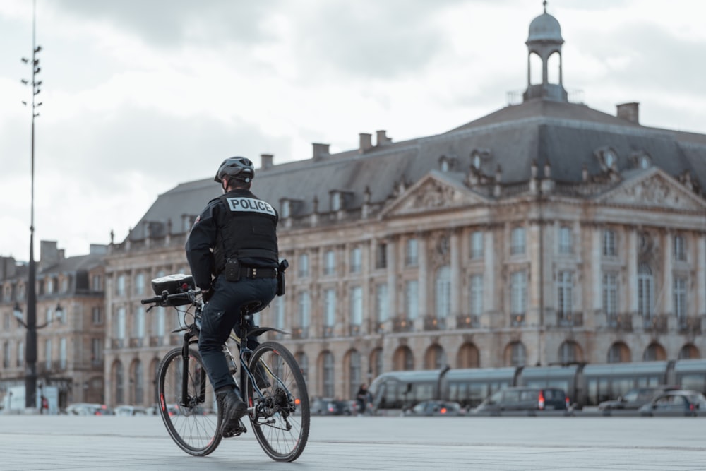 man in black jacket riding bicycle during daytime