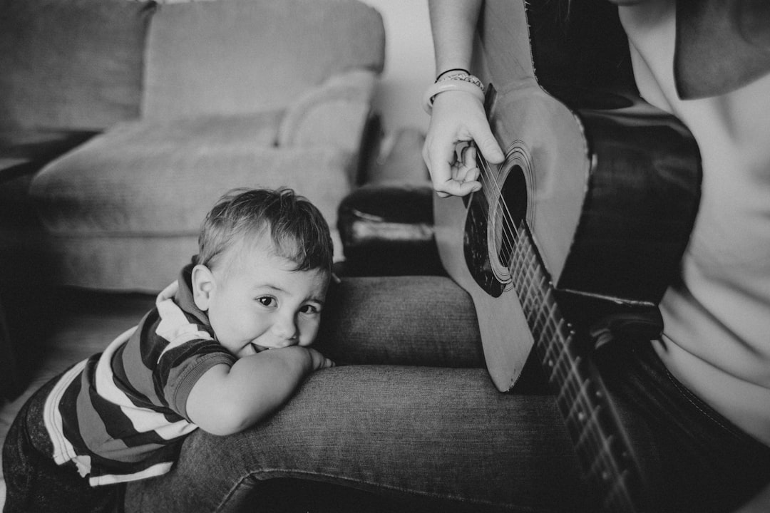 grayscale photo of baby lying on bed