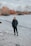 man in black jacket standing on gray sand during daytime