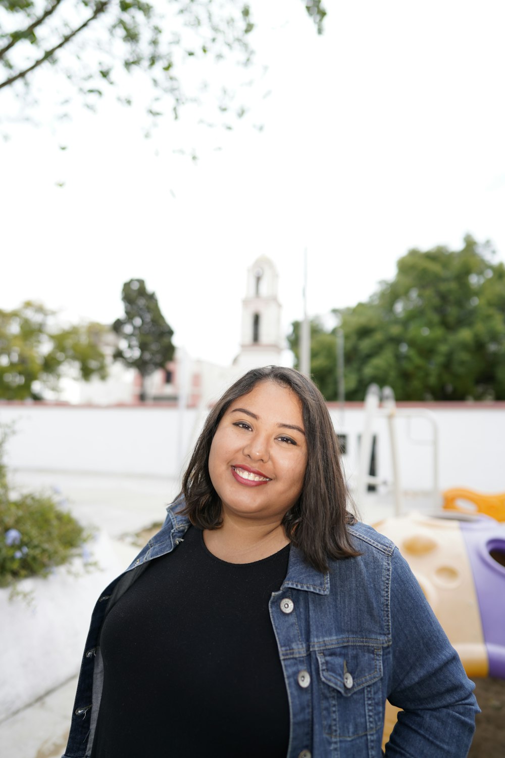 woman in blue denim jacket smiling