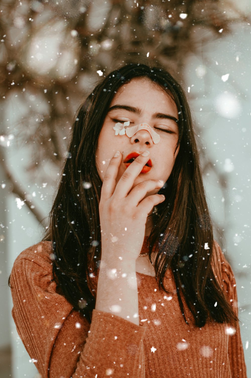 woman in brown knit sweater with red lipstick