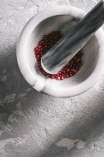 red beads in white round bowl