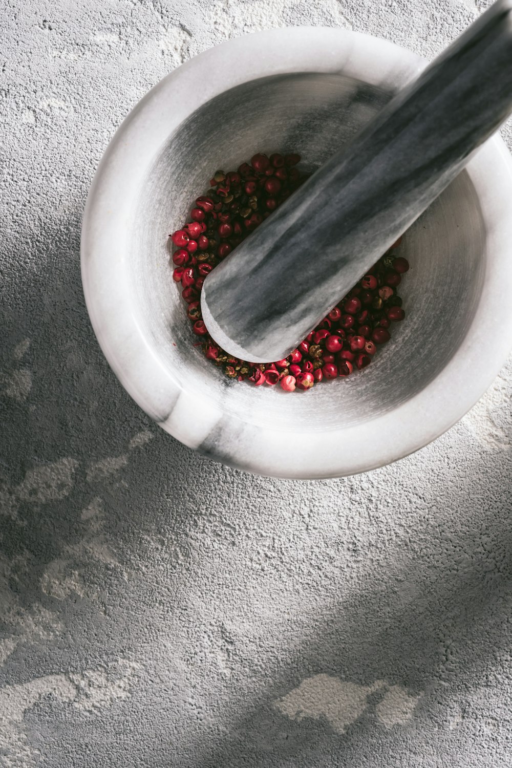 red beads in white round bowl