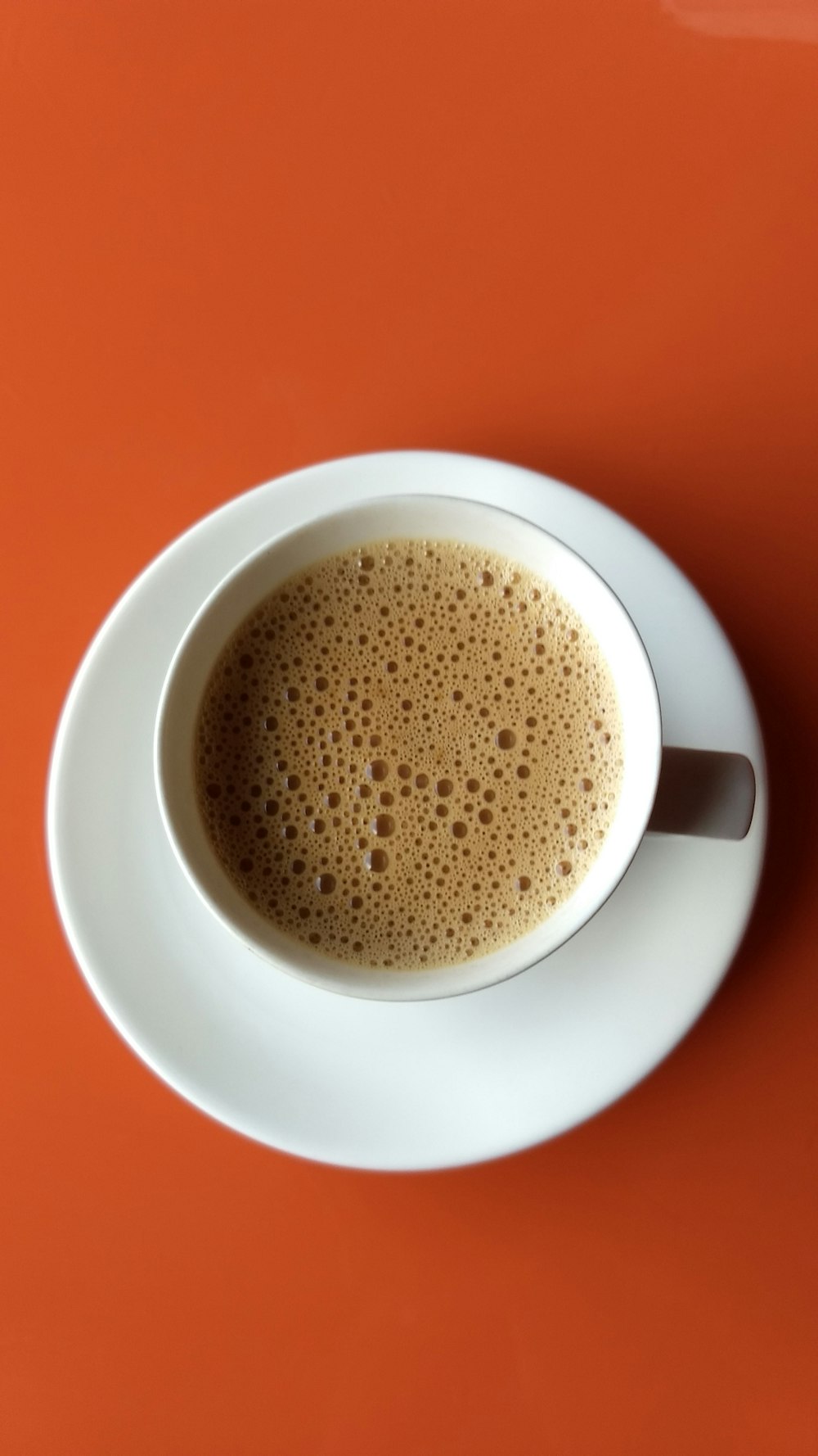 white ceramic mug with brown liquid