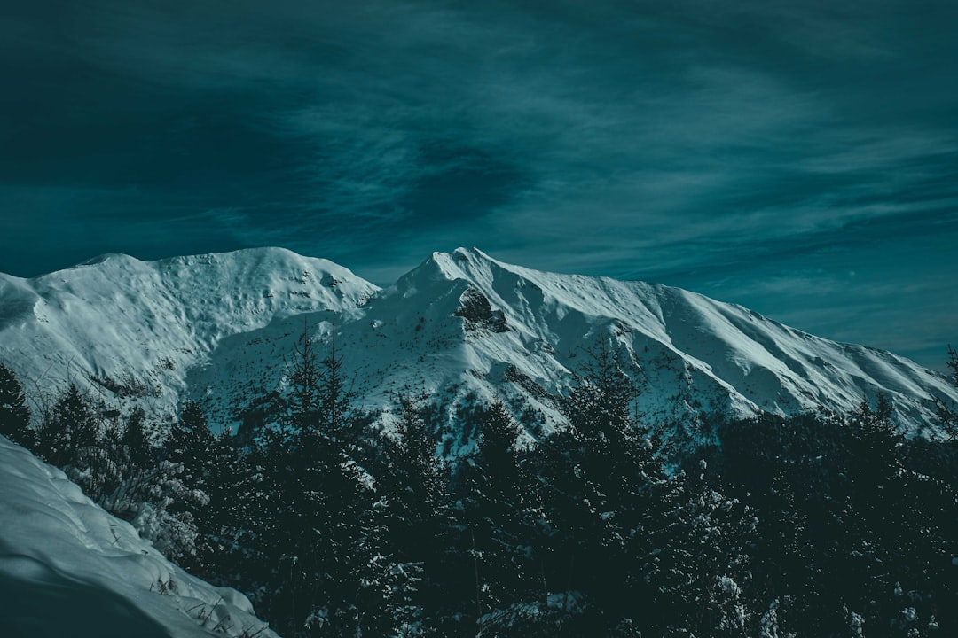 snow covered mountain under cloudy sky during daytime