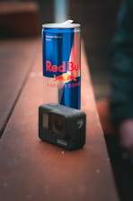 A sleek energy drink bottle with a modern design placed on a wooden surface.