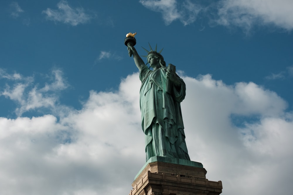 statue of liberty new york under blue sky during daytime