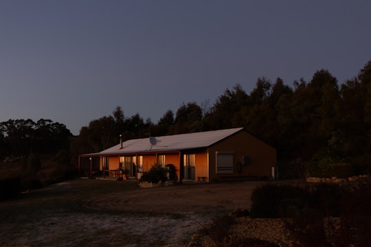 brown wooden house near trees during night time in Jenolan Caves Australia