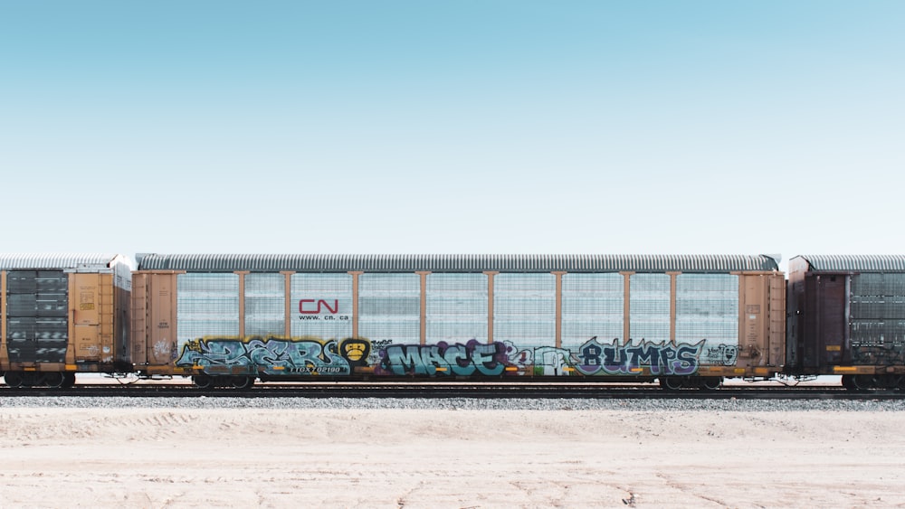 green train on rail road during daytime