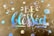 A decorative design features the words 'Be blessed' in iridescent rainbow lettering on a brown paper background. Surrounding the text are several circular dots also in a reflective rainbow pattern, giving a colorful and uplifting visual effect.